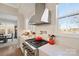 Gourmet kitchen with stainless steel range, hood, and herringbone backsplash at 180 Twin Sisters Ln, Mooresville, NC 28117