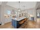 Modern kitchen featuring a large island with seating, stainless steel appliances, and white cabinetry at 180 Twin Sisters Ln, Mooresville, NC 28117