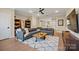Open living room features a large sectional, ceiling fan, and hardwood floors at 180 Twin Sisters Ln, Mooresville, NC 28117