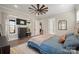 Well-lit main bedroom showcasing modern furnishings, ceiling fan, and convenient access to the bathroom at 180 Twin Sisters Ln, Mooresville, NC 28117
