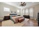 Spacious main bedroom featuring a ceiling fan, soft rug, and a plush bed with designer bedding at 180 Twin Sisters Ln, Mooresville, NC 28117