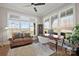 Sun-filled home office with hardwood floors, a stylish desk, and a comfortable seating area at 180 Twin Sisters Ln, Mooresville, NC 28117