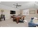 Bright recreation room features a billiards table, large screen TV, and hardwood floors at 180 Twin Sisters Ln, Mooresville, NC 28117