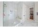 Luxury tiled shower with a glass door, marble surround, and convenient built-in shelving at 180 Twin Sisters Ln, Mooresville, NC 28117