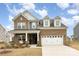 Charming brick home with a two-car garage and covered front porch at 1854 Carrollton Dr, Indian Trail, NC 28079