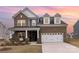 Charming brick home with a two-car garage and covered front porch at 1854 Carrollton Dr, Indian Trail, NC 28079