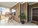 Inviting covered front porch with decorative hanging chair and plant at 1854 Carrollton Dr, Indian Trail, NC 28079