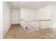 Bright upstairs hallway features hardwood flooring and a traditional wood banister at 1854 Carrollton Dr, Indian Trail, NC 28079