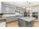 Charming kitchen features a center island, granite counters, gray cabinets, and stainless appliances at 1854 Carrollton Dr, Indian Trail, NC 28079