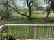 View of the home's spacious backyard, featuring a well-maintained lawn and black metal fencing at 203 S Washington St, Monroe, NC 28112