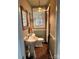 Classic bathroom with pedestal sink, beadboard paneling, and stained glass light at 203 S Washington St, Monroe, NC 28112