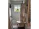 Bright, tiled bathroom featuring hanging plants and modern fixtures at 203 S Washington St, Monroe, NC 28112