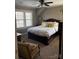 Comfortable bedroom with ceiling fan, plush carpet, and natural light at 203 S Washington St, Monroe, NC 28112