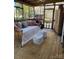 Inviting screened porch with swing bed, area rug, and rustic decor at 203 S Washington St, Monroe, NC 28112