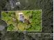 Aerial view of home lot surrounded by mature trees and estimated boundary lines at 207 Windsor Greene Dr, Monroe, NC 28110