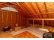 Unfinished attic with exposed rafters, insulation, and storage space at 207 Windsor Greene Dr, Monroe, NC 28110