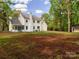 Large backyard with two story home in a wooded setting at 207 Windsor Greene Dr, Monroe, NC 28110
