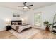 Bright and airy bedroom with a ceiling fan, hardwood floors, and a large window offering natural light at 207 Windsor Greene Dr, Monroe, NC 28110