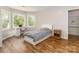 This bedroom has wood floors, a window and a white desk at 207 Windsor Greene Dr, Monroe, NC 28110