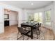 Elegant dining room featuring a large window, hardwood floors, and a stylish dining table at 207 Windsor Greene Dr, Monroe, NC 28110