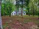 Two-story home nestled among mature trees and lush foliage at 207 Windsor Greene Dr, Monroe, NC 28110