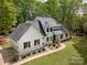 Aerial view of the home showcasing its white brick exterior, dark roof and meticulously landscaped grounds at 207 Windsor Greene Dr, Monroe, NC 28110