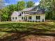Charming two-story home with a well-manicured lawn and complemented by mature trees that offer shade and privacy at 207 Windsor Greene Dr, Monroe, NC 28110