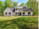 Charming two-story home with a well-manicured lawn and complemented by mature trees that offer shade and privacy at 207 Windsor Greene Dr, Monroe, NC 28110