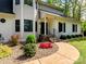 Inviting front entrance with stone steps and lush landscaping, showcasing a charming pathway at 207 Windsor Greene Dr, Monroe, NC 28110