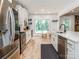 Bright kitchen with stainless steel appliances, white cabinetry, and a view of the outdoors at 207 Windsor Greene Dr, Monroe, NC 28110