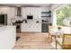 Eat-in kitchen featuring white cabinetry, stainless appliances, subway tile backsplash, and a large window at 207 Windsor Greene Dr, Monroe, NC 28110