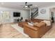 Comfortable living room with large sectional sofa, television, and access to the screened porch at 207 Windsor Greene Dr, Monroe, NC 28110