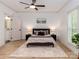 Main bedroom features a neutral color palette, wood floors, en-suite bathroom, and natural lighting at 207 Windsor Greene Dr, Monroe, NC 28110