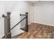 A staircase with gray railings and newel posts leads upstairs at 207 Windsor Greene Dr, Monroe, NC 28110