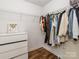 The well-organized walk-in closet includes shelving, clothing racks, and a dresser at 207 Windsor Greene Dr, Monroe, NC 28110