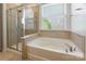 Modern bathroom with a tub and shower with a glass door at 2243 Creek View Ct, Indian Land, SC 29707