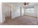 A clean bedroom has a ceiling fan and window with light coming in at 2243 Creek View Ct, Indian Land, SC 29707