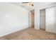 This bedroom offers plush carpeting, a ceiling fan, and closet for plenty of storage space at 2243 Creek View Ct, Indian Land, SC 29707