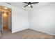 This bedroom offers plush carpeting, a ceiling fan, and closet for plenty of storage space at 2243 Creek View Ct, Indian Land, SC 29707