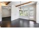 Bright dining area featuring hardwood floors, a modern chandelier, and a door leading to the outdoor patio with a hot tub at 2243 Creek View Ct, Indian Land, SC 29707