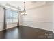 Elegant dining room with modern chandelier and large window at 2243 Creek View Ct, Indian Land, SC 29707