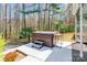 Backyard view of the hot tub with a surrounding patio and luscious greenery at 2243 Creek View Ct, Indian Land, SC 29707