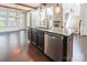 Kitchen island with stainless steel dishwasher and sink, and hardwood floors at 2243 Creek View Ct, Indian Land, SC 29707