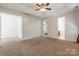 A clean main bedroom has a ceiling fan and two doors leading to the closet and bathroom at 2243 Creek View Ct, Indian Land, SC 29707