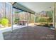 Covered patio area featuring a hot tub with privacy from the surrounding trees at 2243 Creek View Ct, Indian Land, SC 29707