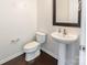 Neat powder room with a pedestal sink, a framed mirror, and hardwood flooring at 2243 Creek View Ct, Indian Land, SC 29707