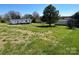 Expansive backyard with lush green grass and mature trees, offering plenty of open space at 24257 Austin Rd, Albemarle, NC 28001