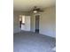 A spacious bedroom featuring a ceiling fan, carpet floors, and a closet for storage at 24257 Austin Rd, Albemarle, NC 28001