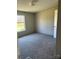 A cozy bedroom featuring plush carpeting, a window with a view, and neutral wall colors at 24257 Austin Rd, Albemarle, NC 28001