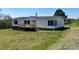 Charming home featuring a front porch, dark shutters, and a well maintained lawn at 24257 Austin Rd, Albemarle, NC 28001